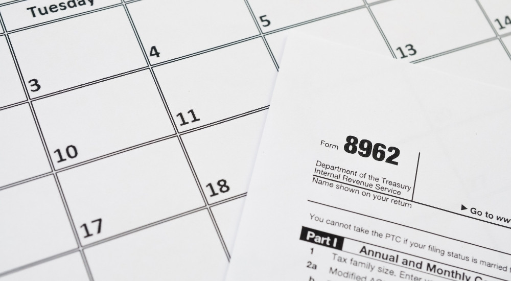 The 8962 printable form is lying on the table with a blank calendar template